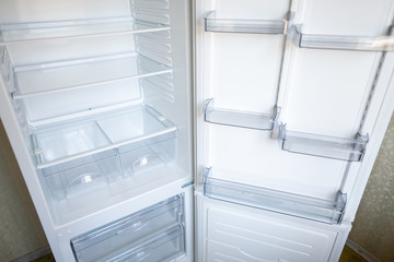 Empty shelves in refrigerator. The concept of diet and hunger