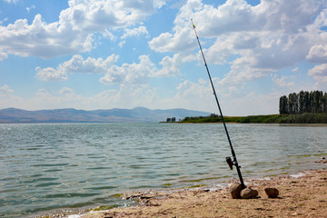 amateur fishing with fishing rod on the lake