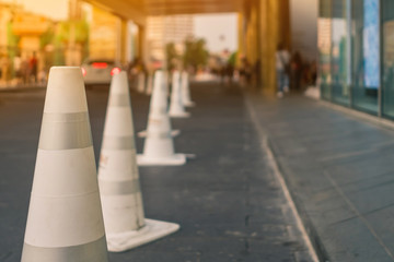 The white traffic cones are set up as a pedestrian safety zone in front of the mall.