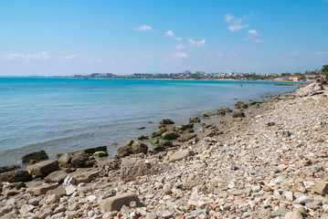 Sunny summer view of a coastline and beach near blue mediterranean sea. Beautiful world of mediterranean countries..