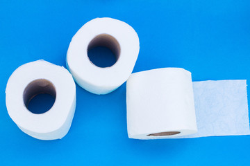 Rolls of toilet paper on blue background