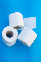 Toilet paper-Tissue paper roll. The reel of the toilet paper on the blue background. Roll of toilet paper- Cheap wc wiping paper product hygienic purposes.Rolls of toilet paper. Wc papers.N