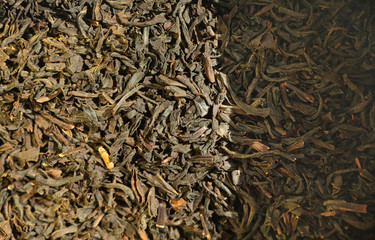 Black tea background. Dry tea leaves.