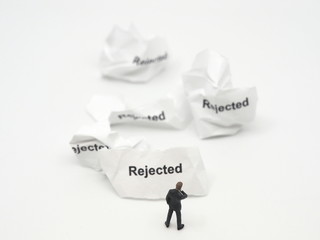 A miniature businessman who has had his proposal rejected many times and is thinking deeply about...