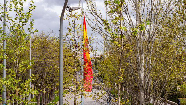 different images of a flag of spain waving in marques de vadillo with the bridge of toledo in the background