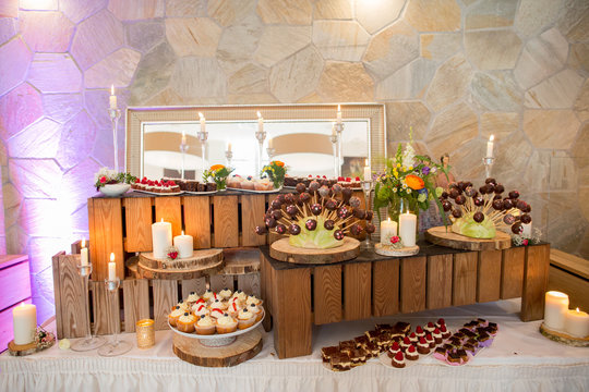 Delicious candy bar with macaroons, cupcakes and other sweets