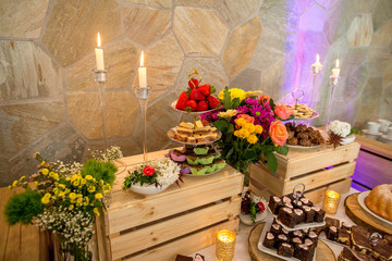 Naklejka premium Delicious candy bar with macaroons, cupcakes and other sweets