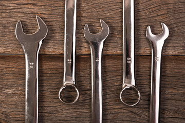 wrenches on wooden background