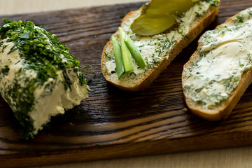 Rustic homemade cottage cheese with herbs, cream cheese. Sandwiches with homemade cheese, pickled cucumber, green onion and egg. Top view, side view, text space