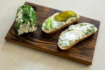 Rustic homemade cottage cheese with herbs, cream cheese. Sandwiches with homemade cheese, pickled cucumber, green onion and egg. Top view, side view, text space