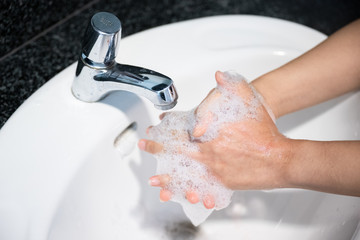 Close up of hands washing by sanitizer gel pump bottle, alcohol gel for prevention coronavirus disesse 2019 (COVID-19), bacteria and germ, health care concept (select focus)