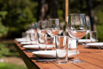 Served wooden table without a tablecloth. Cafe in the open air park
