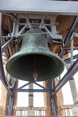 Fototapeta premium A large copper bell hangs on a bell tower Torre Dei Lamberti in Verona, Italy