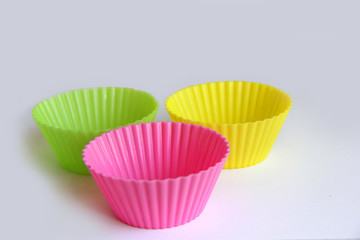 colorful cupcake cups on white background