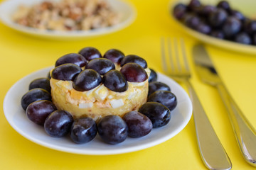 The legendary Tiffany layered salad with grapes, chicken and cheese on the yellow background.