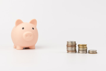 Piggybank and money tower. Pink piggy Bank isolated on white background. Concept of savings.