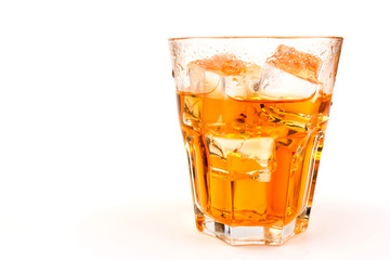 Glass of scotch whiskey and ice over white background.