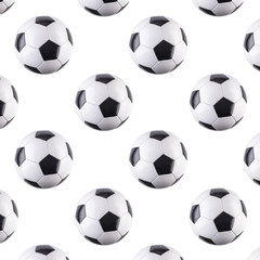 Seamless pattern of balls. Black and white soccer balls flying in the air, isolated on white...