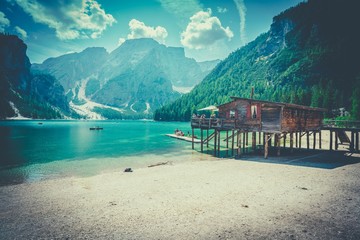 lake with crystal clear water close to the mountains with boathouse