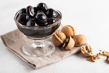 walnut jam in a jar on a white background