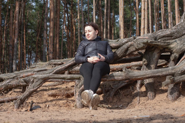 A girl on the beach basks in the first spring sun