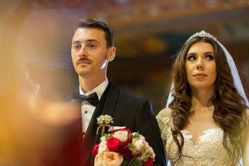 Handsome wedding couple posing in church