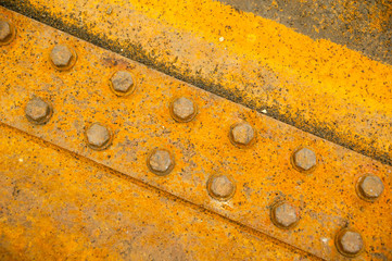 Rusty nut at the surface of steel plate closeup