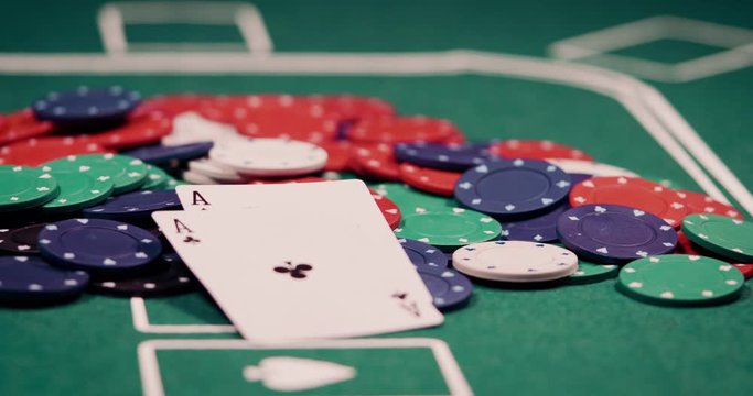 Close up of pocket rockets two aces got thrown on a heap of chips in the middle of the poker table shot in 4k super slow motion