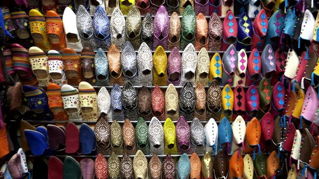 pan of retail display of colorful shoes at the main market in marrakech, morroco