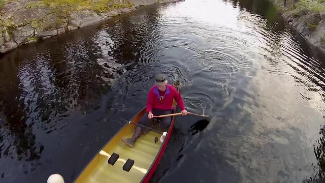 Paddling a river between two lakes in the rocky Canadian Shield country of eastern Manitoba.