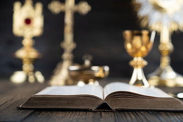 Catholic religion concept. Catholic symbols composition. The Cross, monstrance,  Holy Bible and...