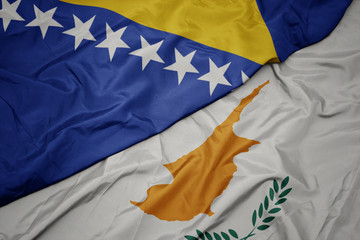 waving colorful flag of cyprus and national flag of bosnia and herzegovina.