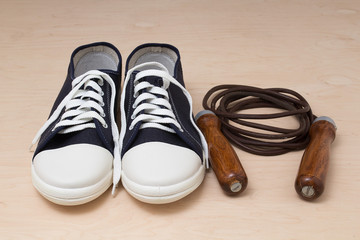 New sports shoes and jumping rope with wooden handles