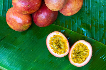 Ripe passion fruit, on a wet banana leaf. Vitamins, fruits, healthy foods