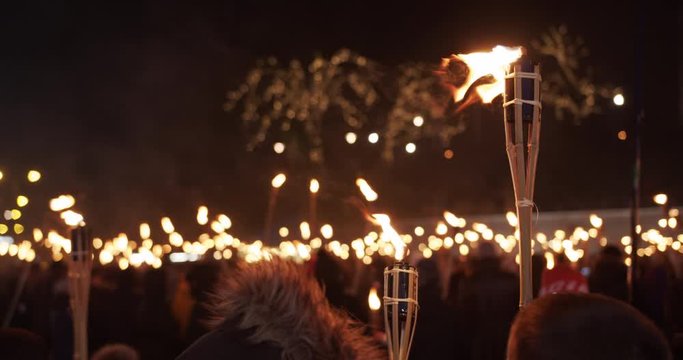 Torchlight procession at night people protest with burning torches