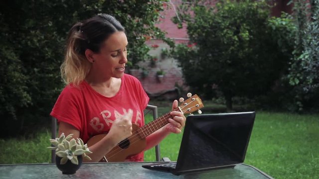 Woman playing a Charango at her Garden, during the Covid-19 Pandemic.