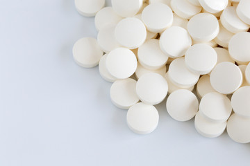 Fototapeta na wymiar Pills tablets vitamins drugs white close up macro shot