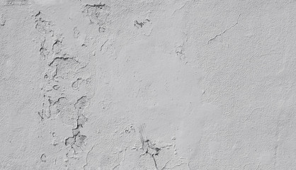 Close-up of a weathered and old concrete wall, paint is peeling off. High resolution abstract full frame textured background in black and white.