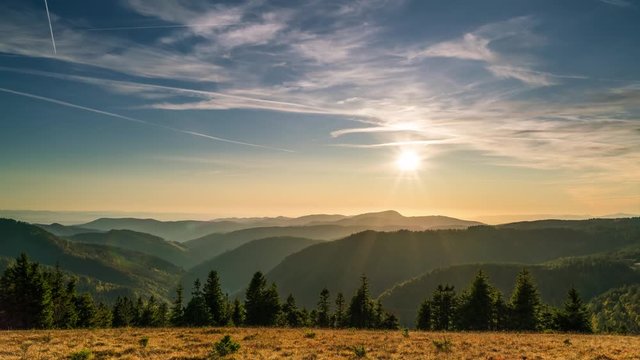 Time-lapse silhouette of sun and mountains at sunset