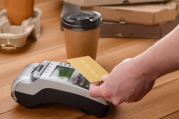 Customer paying for take-away coffee with a single tap