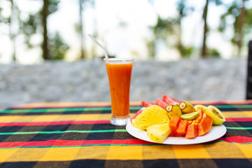Fruit plate. Fresh, juicy fruits in a plate on a background of mountains