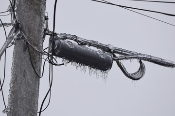 power line transformer covered in ice, closeup power line transformer covered in ice, closeup 