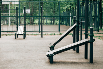 An empty training ground (workout) on the street, horizontal bars and benches for exercise on the press.