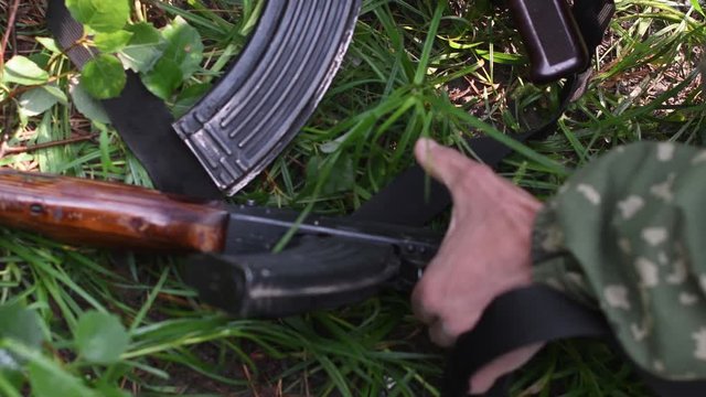 military man raises a weapon