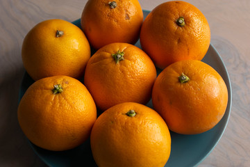Fruit plate with oranges on a dining table for healthy dish