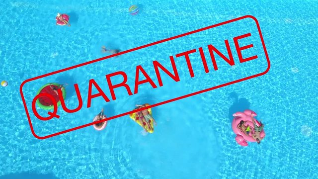 AERIAL, TOP DOWN: Large red quarantine sign covers a group of playful tourists partying in a pool as all upcoming events are cancelled until further notice because of the global coronavirus pandemic.