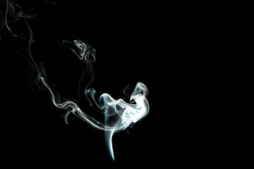 puffs of white smoke with a black background