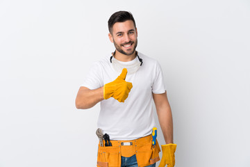 Craftsmen or electrician man over isolated white background giving a thumbs up gesture