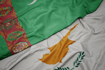 waving colorful flag of cyprus and national flag of turkmenistan.