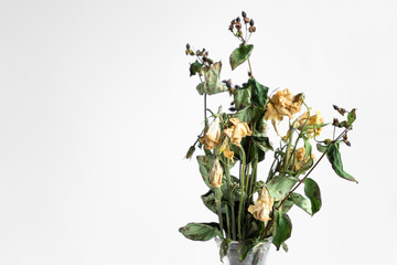 Bouquet of wilted flowers on a white background
